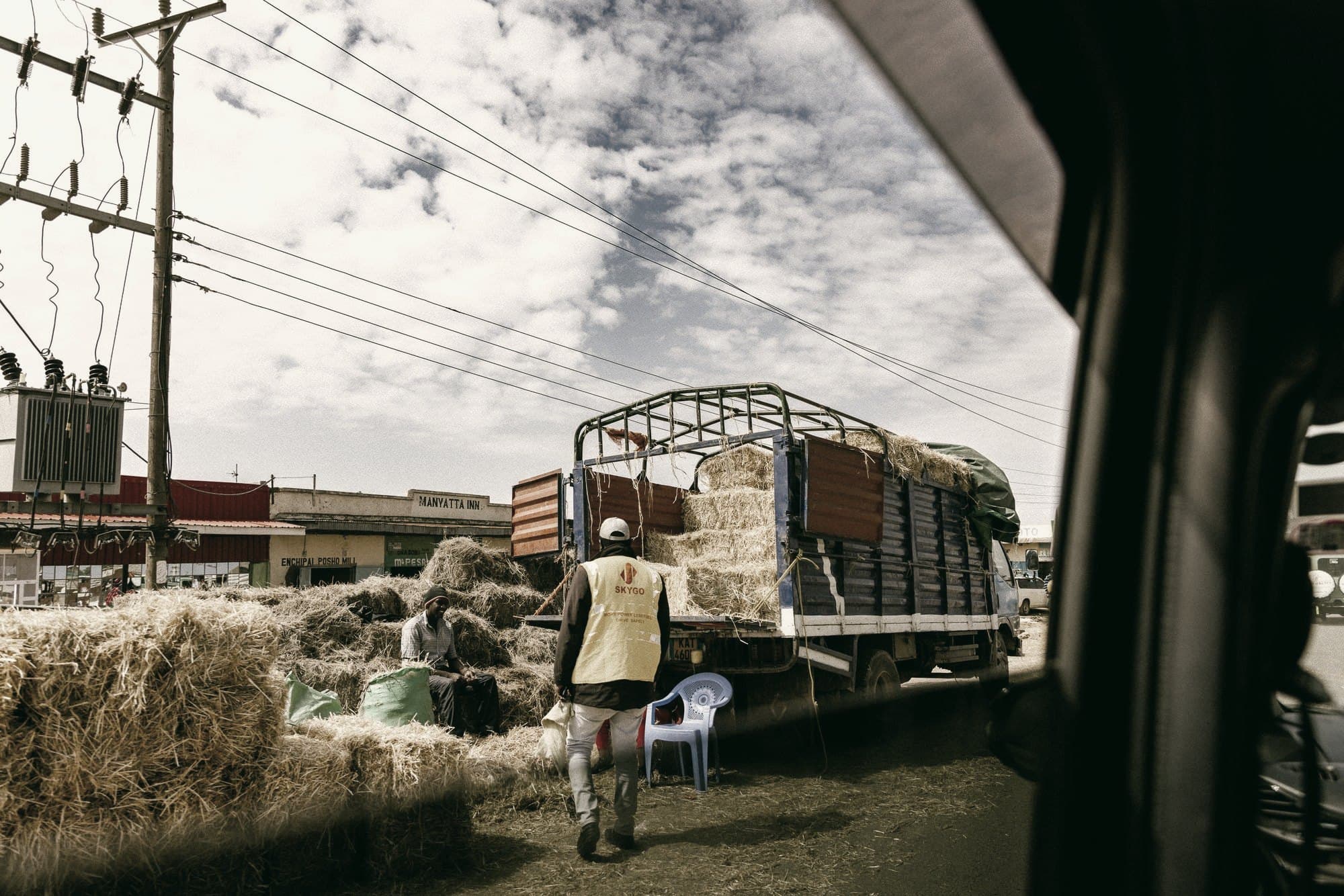 A busy Nairobi market with a truck being unloaded